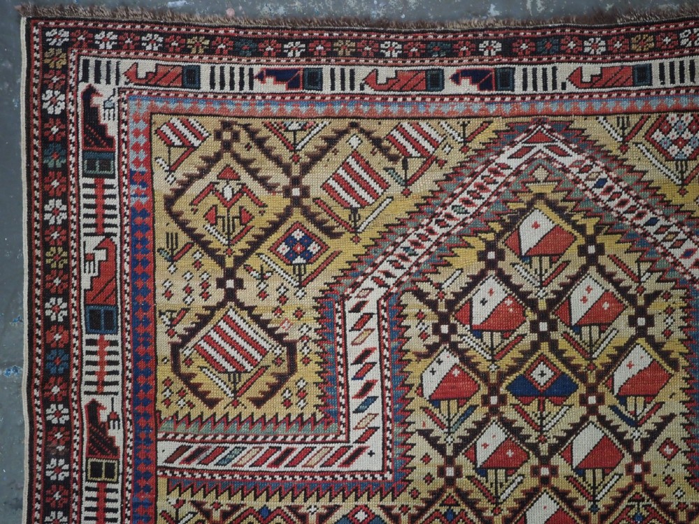 A hand-knotted Caucasian Marasali prayer rug featuring a yellow ground with a prominent pointed mihrab arch, diamond lattice patterns, and geometric borders in red, blue, and brown. View II