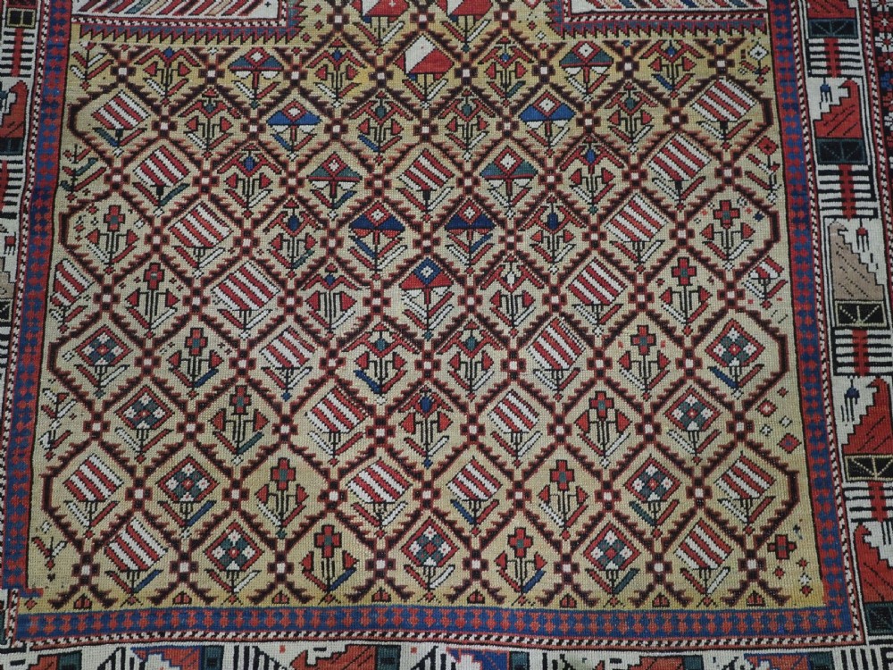 A hand-knotted Caucasian Marasali prayer rug featuring a yellow ground with a prominent pointed mihrab arch, diamond lattice patterns, and geometric borders in red, blue, and brown. View VIII