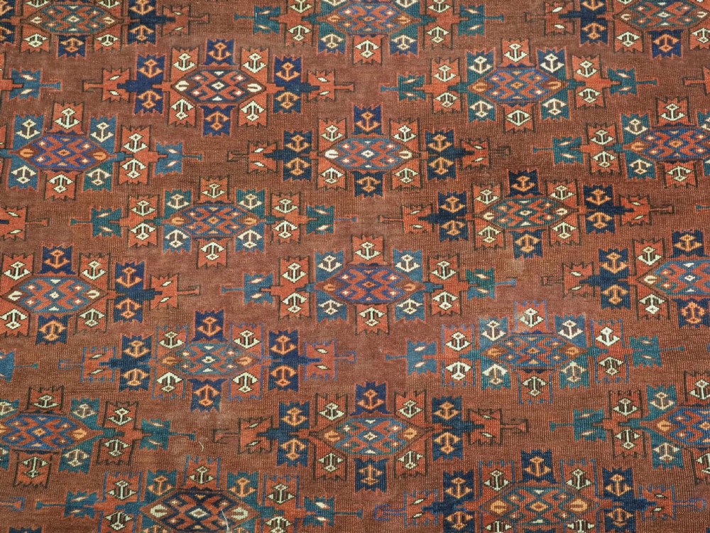 An antique Yomut Turkmen hand-knotted wool carpet featuring repeating Kepse gul geometric diamond patterns in deep red, navy, and cream. View XI