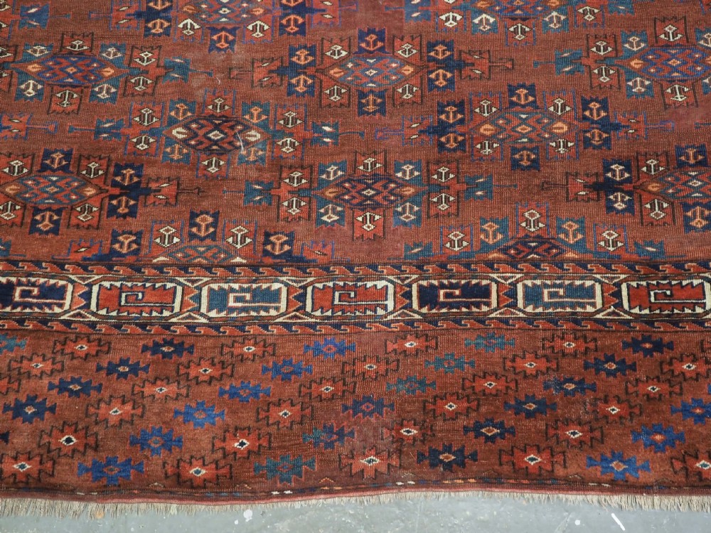 An antique Yomut Turkmen hand-knotted wool carpet featuring repeating Kepse gul geometric diamond patterns in deep red, navy, and cream. View XIII