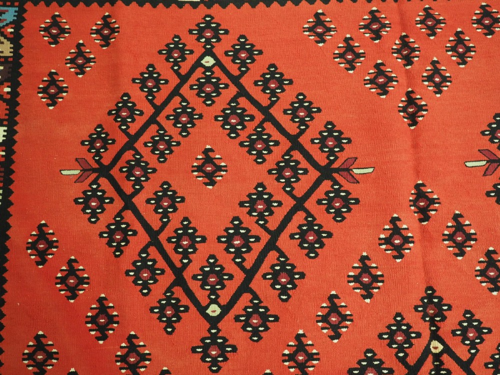 An antique red flat-weave Pirot Sarkoy wool kilim featuring geometric diamond motifs and a multi-coloured decorative border. View VIII