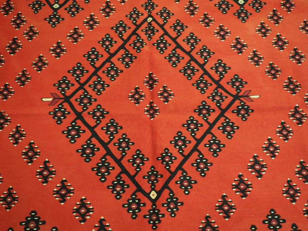 An antique red flat-weave Pirot Sarkoy wool kilim featuring geometric diamond motifs and a multi-coloured decorative border. View IX