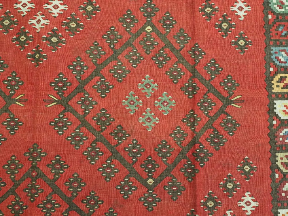 A red flatwoven antique Pirot Sarkoy kilim featuring geometric diamond motifs with intricate multi-coloured borders. View VIII