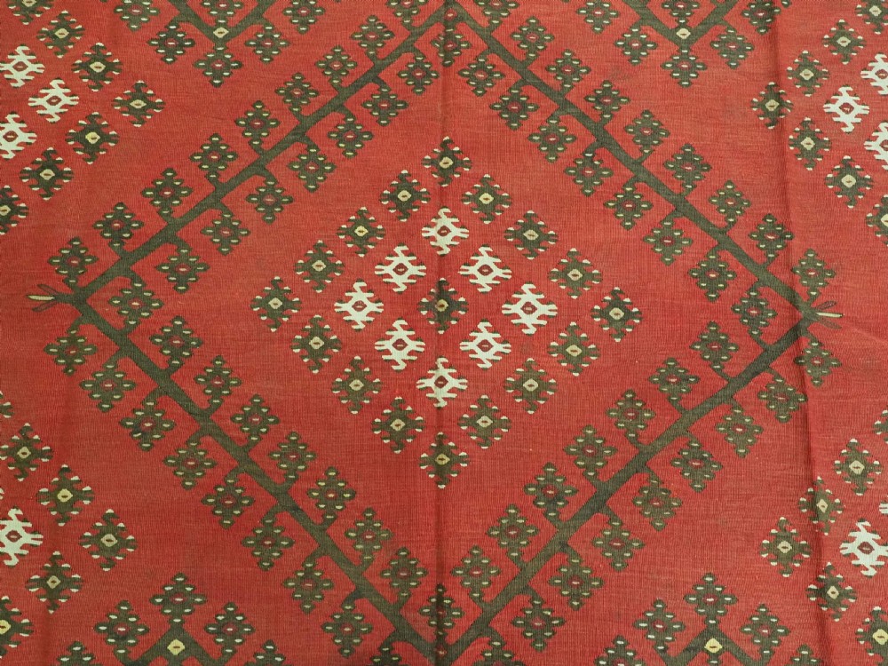 A red flatwoven antique Pirot Sarkoy kilim featuring geometric diamond motifs with intricate multi-coloured borders. View IX