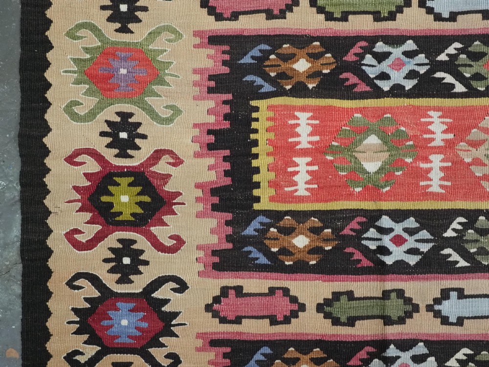A handwoven antique Pirot Sarkoy flatweave wool kilim rug featuring horizontal bands of geometric motifs in terracotta, beige, yellow, green, and dark brown. View VII