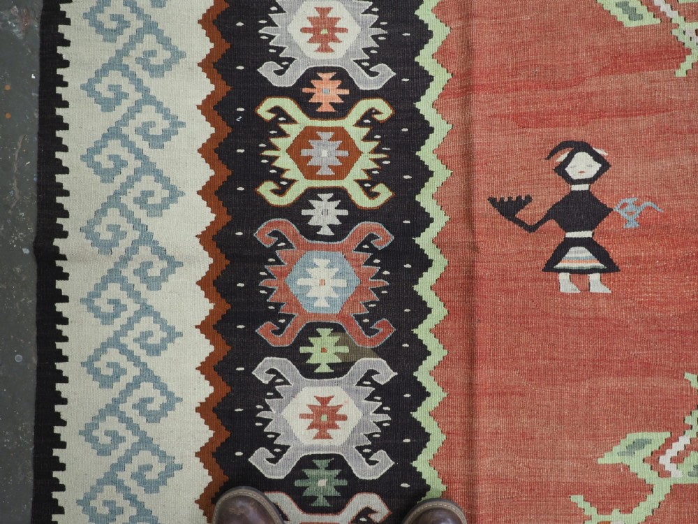 An antique woven wool Pirot Sarkoy kilim rug featuring a central terracotta red field decorated with diamond medallions and intricate geometric borders. View VII