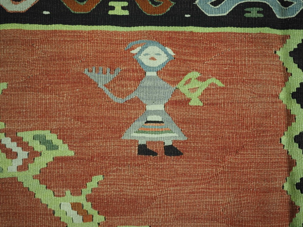 An antique woven wool Pirot Sarkoy kilim rug featuring a central terracotta red field decorated with diamond medallions and intricate geometric borders. View IX