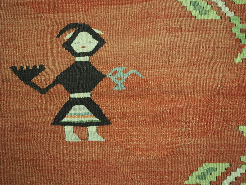 An antique woven wool Pirot Sarkoy kilim rug featuring a central terracotta red field decorated with diamond medallions and intricate geometric borders. View XI