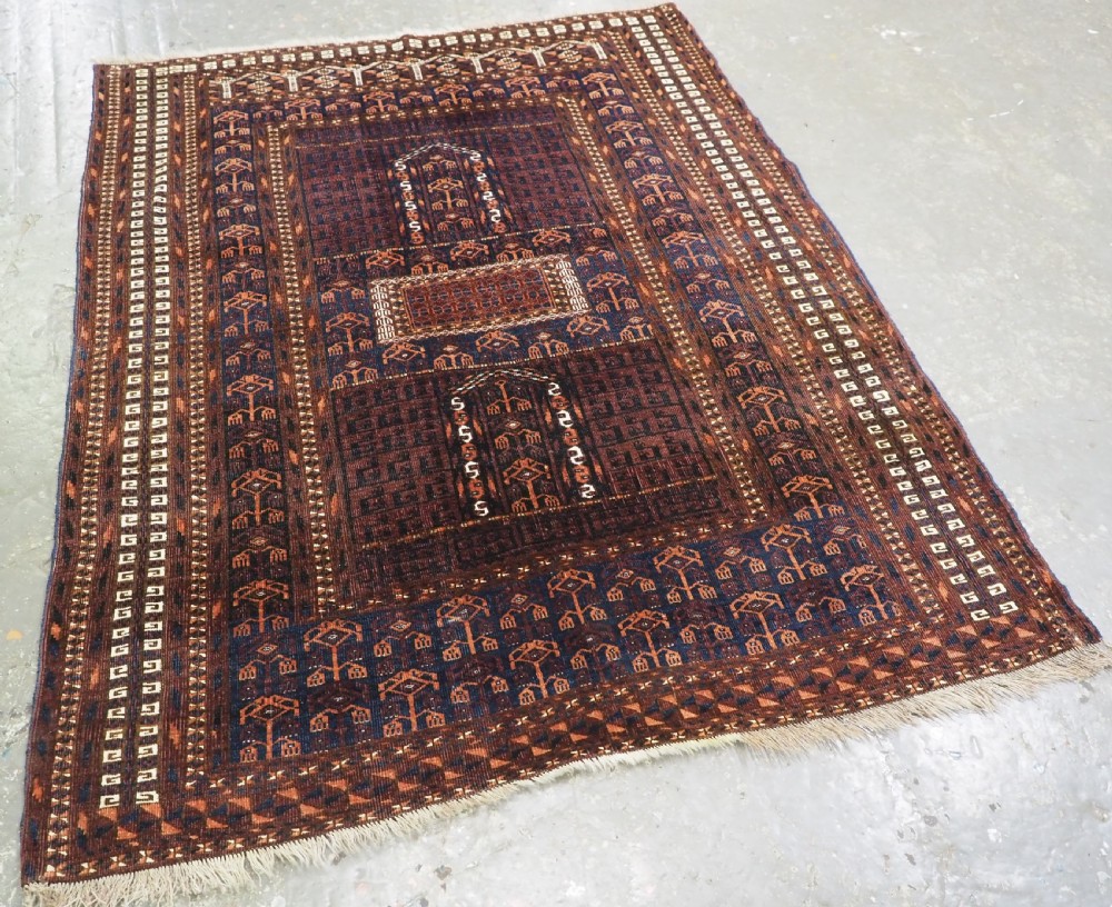 An antique 19th-century Saryk Turkmen ensi rug with a dark reddish-brown field featuring geometric cross divisions and white cotton highlights. View II