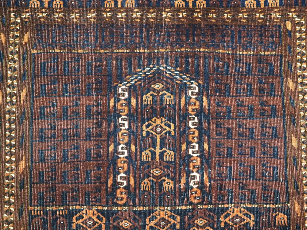 An antique 19th-century Saryk Turkmen ensi rug with a dark reddish-brown field featuring geometric cross divisions and white cotton highlights. View IX
