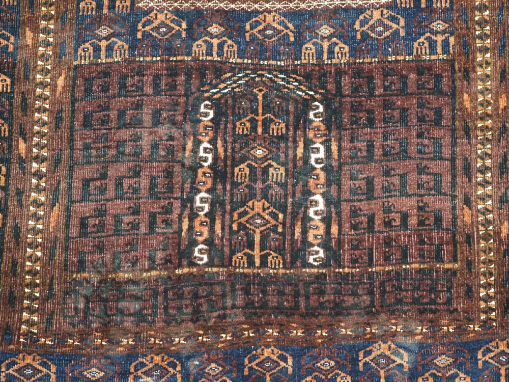 An antique 19th-century Saryk Turkmen ensi rug with a dark reddish-brown field featuring geometric cross divisions and white cotton highlights. View XI