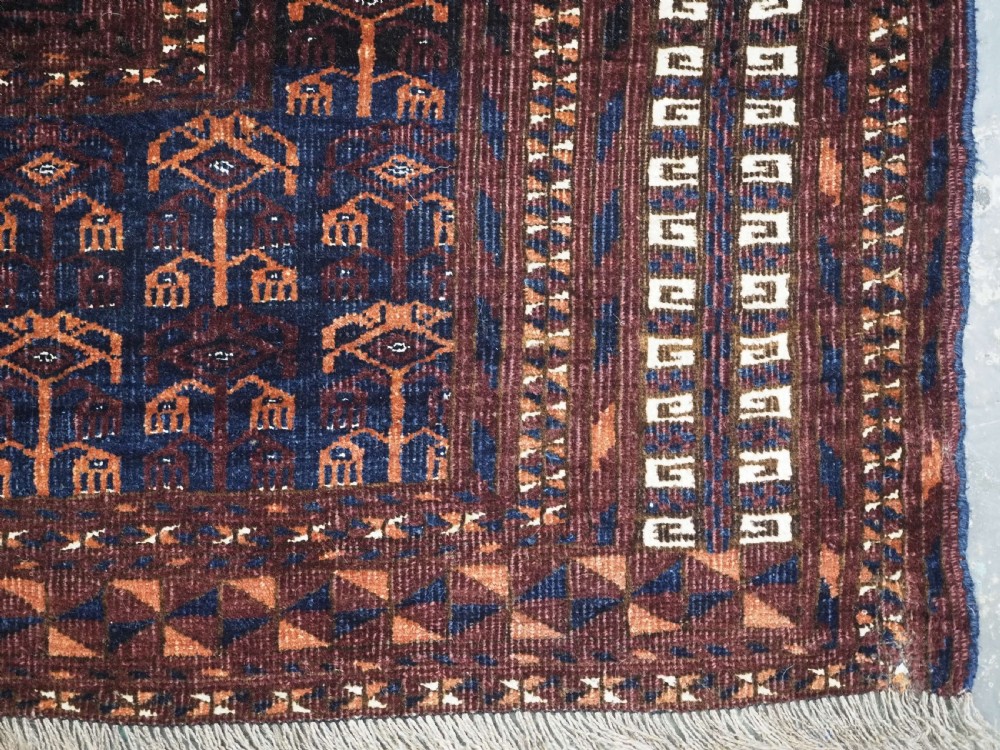 An antique 19th-century Saryk Turkmen ensi rug with a dark reddish-brown field featuring geometric cross divisions and white cotton highlights. View XIII