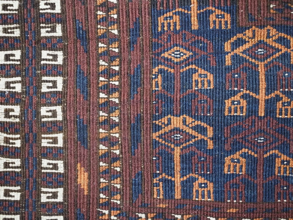 An antique 19th-century Saryk Turkmen ensi rug with a dark reddish-brown field featuring geometric cross divisions and white cotton highlights. View XIV