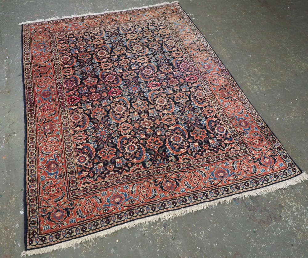 An antique hand-knotted wool Tabriz rug featuring a dense repeating Herati design in navy blue, terracotta, and beige with a multi-band decorative border. View II