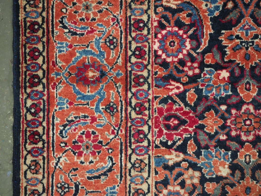 An antique hand-knotted wool Tabriz rug featuring a dense repeating Herati design in navy blue, terracotta, and beige with a multi-band decorative border. View VII