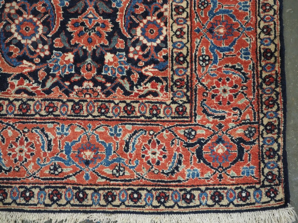 An antique hand-knotted wool Tabriz rug featuring a dense repeating Herati design in navy blue, terracotta, and beige with a multi-band decorative border. View XI