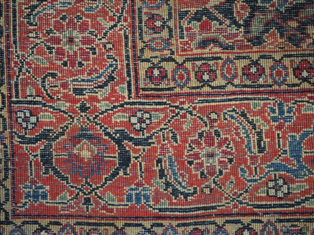 An antique hand-knotted wool Tabriz rug featuring a dense repeating Herati design in navy blue, terracotta, and beige with a multi-band decorative border. View XII