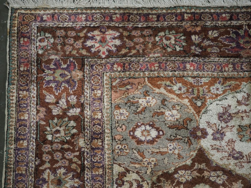 A rectangular vintage Turkish Kayseri rug featuring intricate floral lattice motifs and medallions in shades of brown, terracotta, purple, and green with a decorative bordered edge and fringed ends. View VI