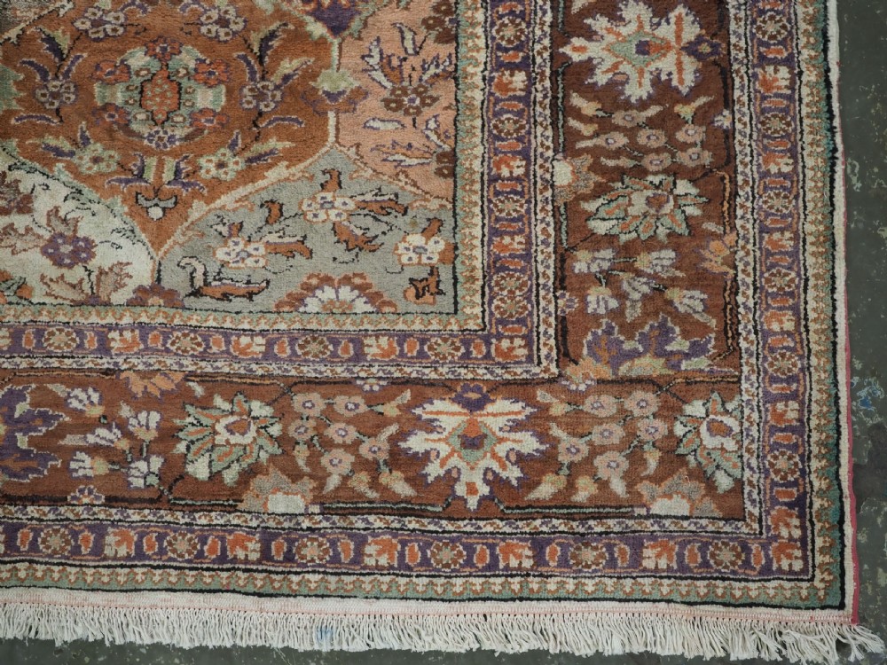 A rectangular vintage Turkish Kayseri rug featuring intricate floral lattice motifs and medallions in shades of brown, terracotta, purple, and green with a decorative bordered edge and fringed ends. View XI