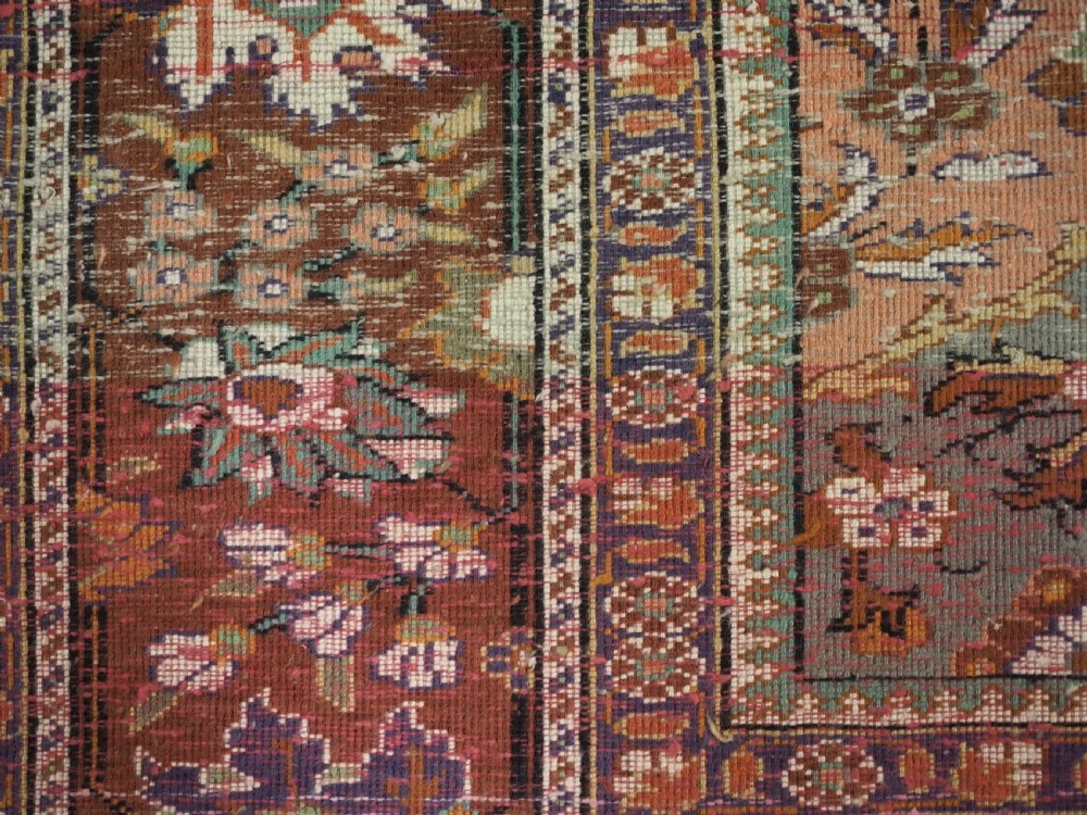 A rectangular vintage Turkish Kayseri rug featuring intricate floral lattice motifs and medallions in shades of brown, terracotta, purple, and green with a decorative bordered edge and fringed ends. View XII