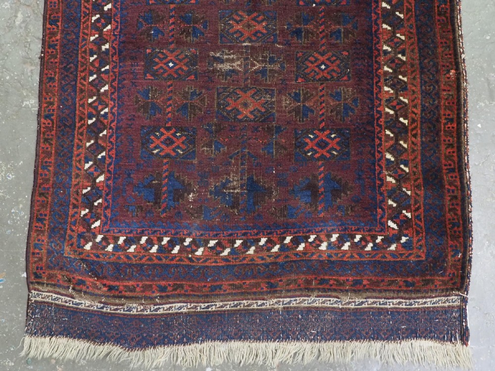 An antique hand-knotted wool prayer rug featuring a defined mihrab arch, geometric box patterns, and deep aubergine, rust red, and indigo blue tones. View V