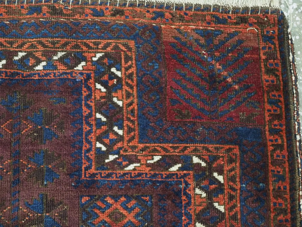 An antique hand-knotted wool prayer rug featuring a defined mihrab arch, geometric box patterns, and deep aubergine, rust red, and indigo blue tones. View VII