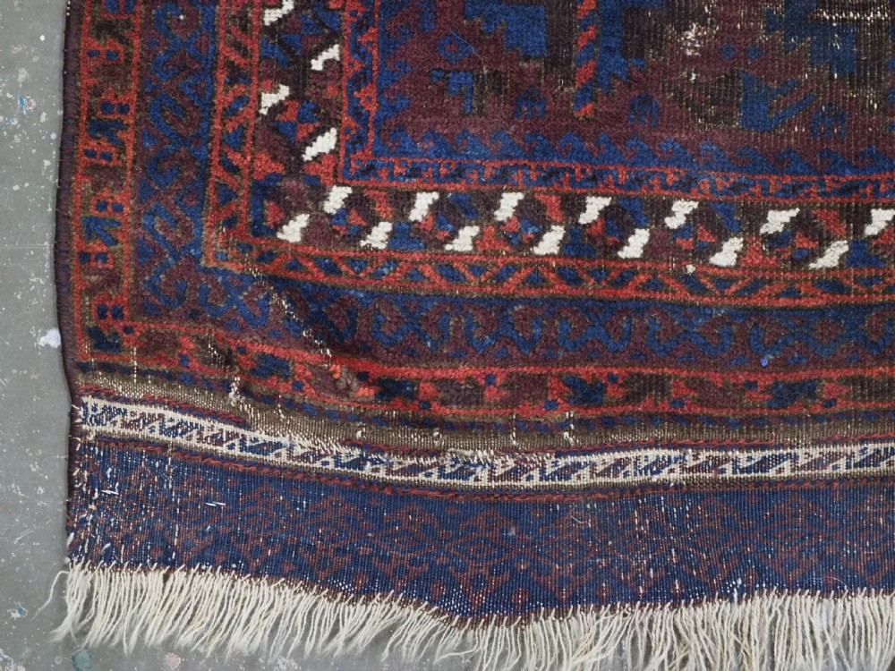 An antique hand-knotted wool prayer rug featuring a defined mihrab arch, geometric box patterns, and deep aubergine, rust red, and indigo blue tones. View IX