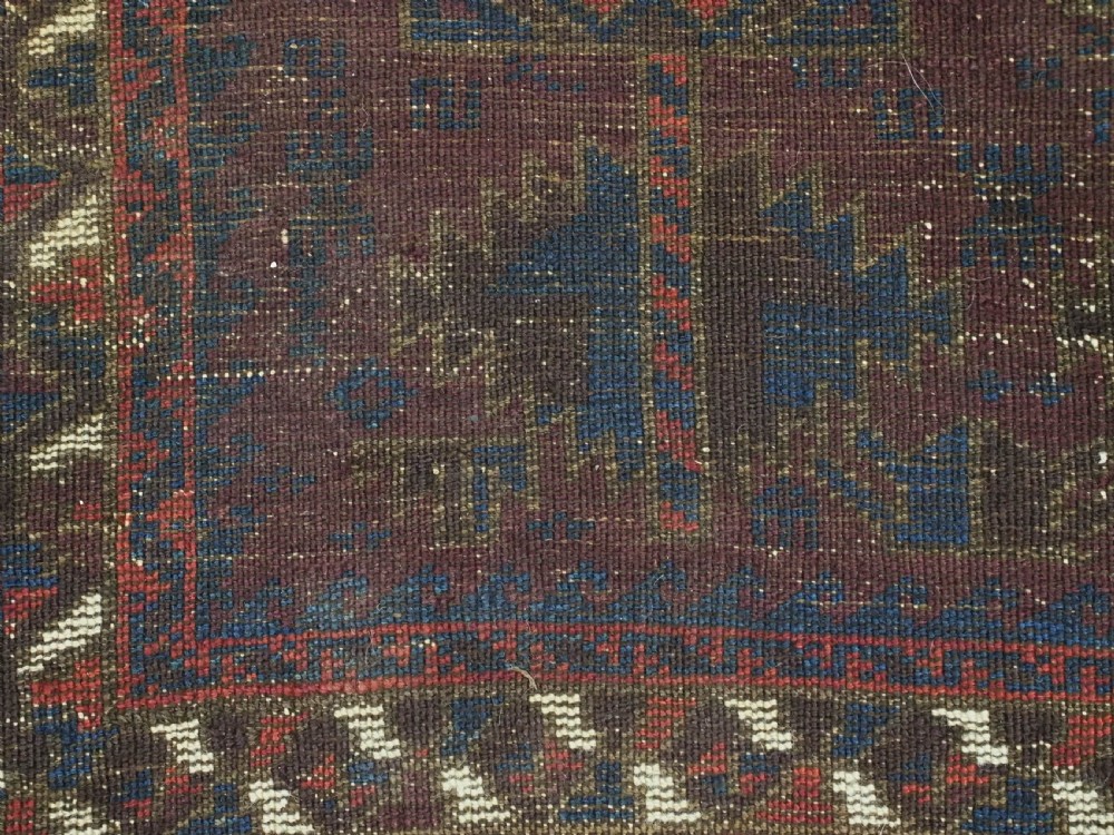 An antique hand-knotted wool prayer rug featuring a defined mihrab arch, geometric box patterns, and deep aubergine, rust red, and indigo blue tones. View XI