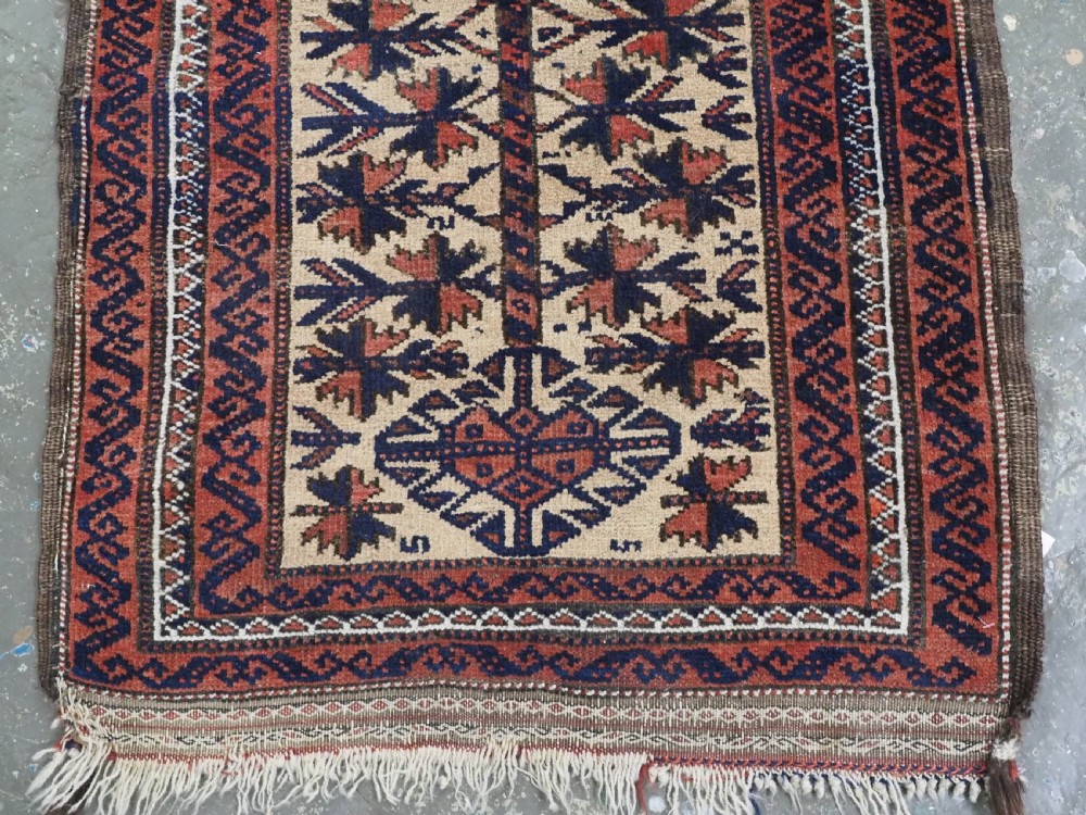 An antique hand-knotted Baluch prayer rug featuring a camel-coloured ground, central tree of life motif, mihrab arch, and decorative geometric borders. View V