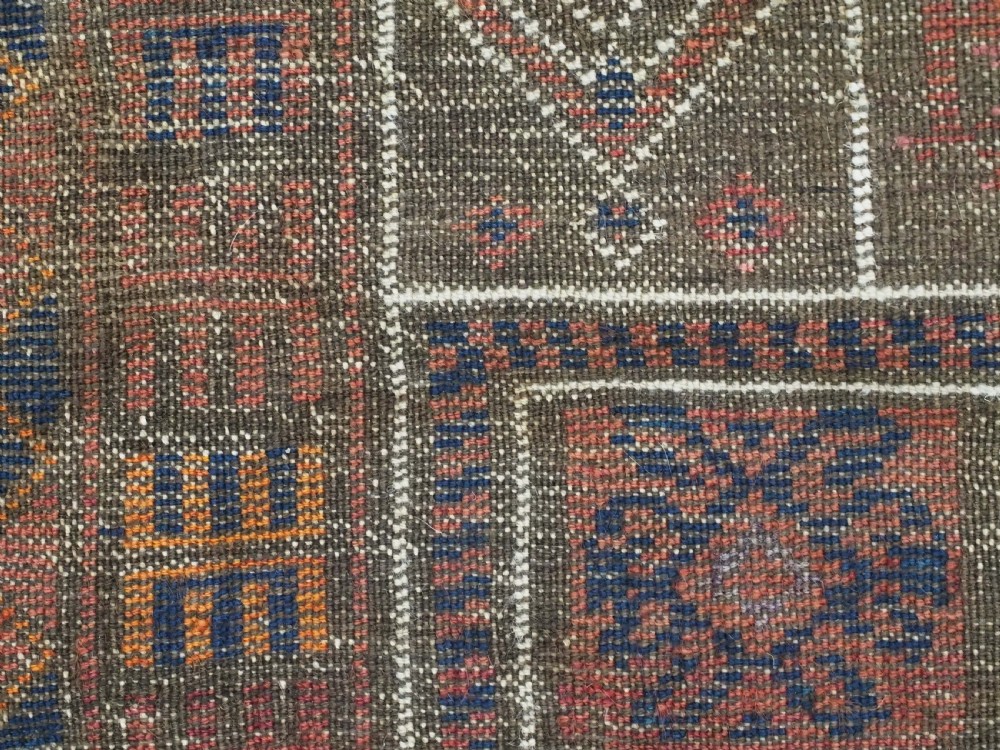 An antique hand-knotted wool prayer rug featuring a three-niche architectural design in terracotta, dark brown, and indigo blue tones with fringed edges. View XIII