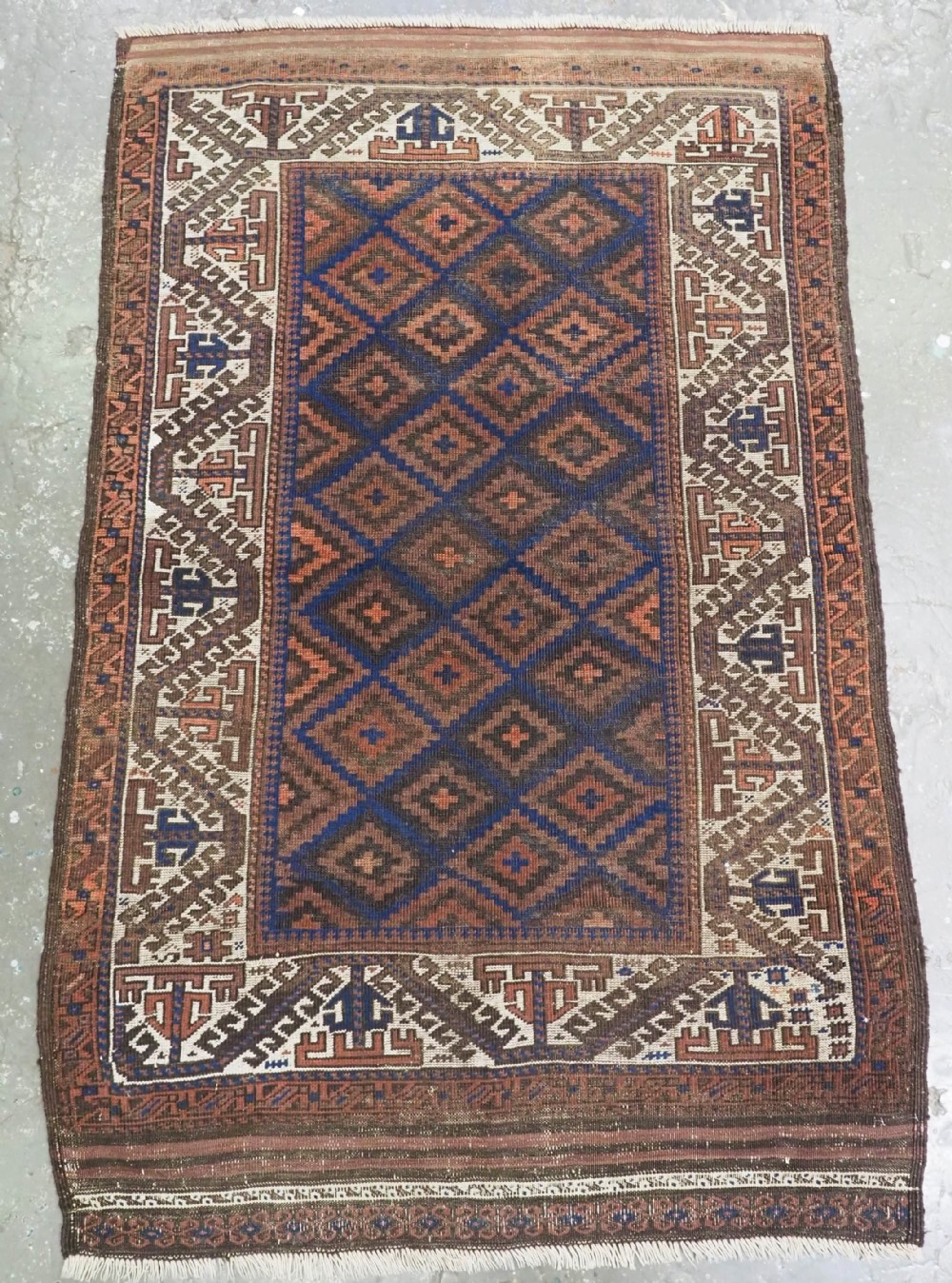 ANTIQUE TIMURI OR BALUCH RUG, LARGE IVORY BORDER, CIRCA 1880.