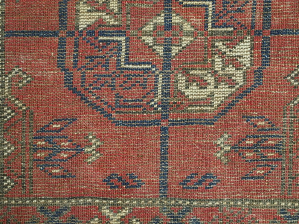 A hand-knotted antique Baluch prayer rug featuring a deep red ground, geometric octagonal medallions, an arched mihrab motif at the top, and multi-band patterned borders. View XIII