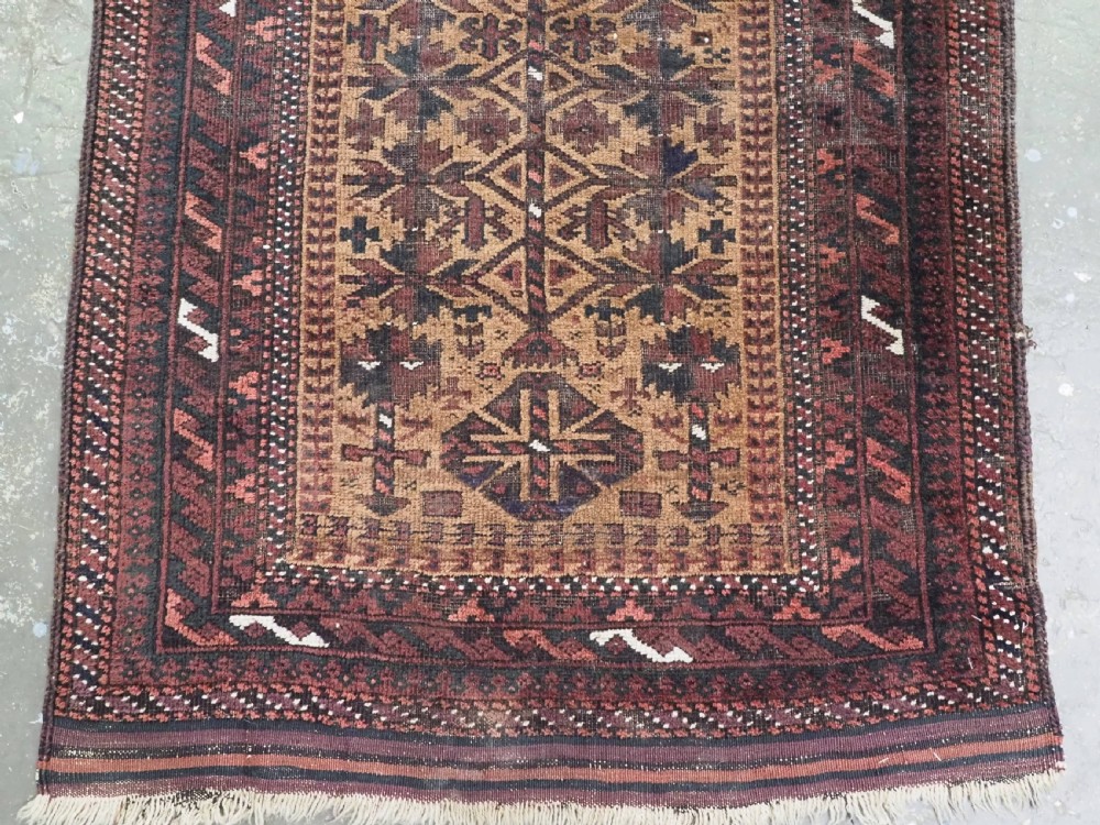 An antique woven Baluch prayer rug with a central tree of life design in camel brown and dark red tones. View V