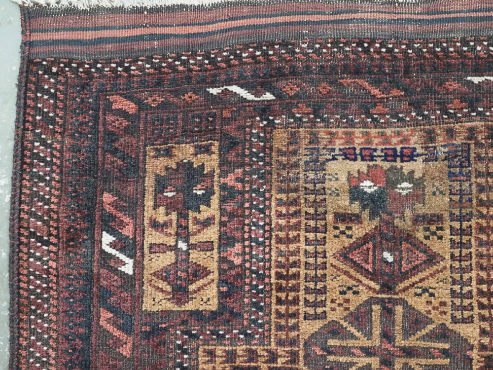 An antique woven Baluch prayer rug with a central tree of life design in camel brown and dark red tones. View VI