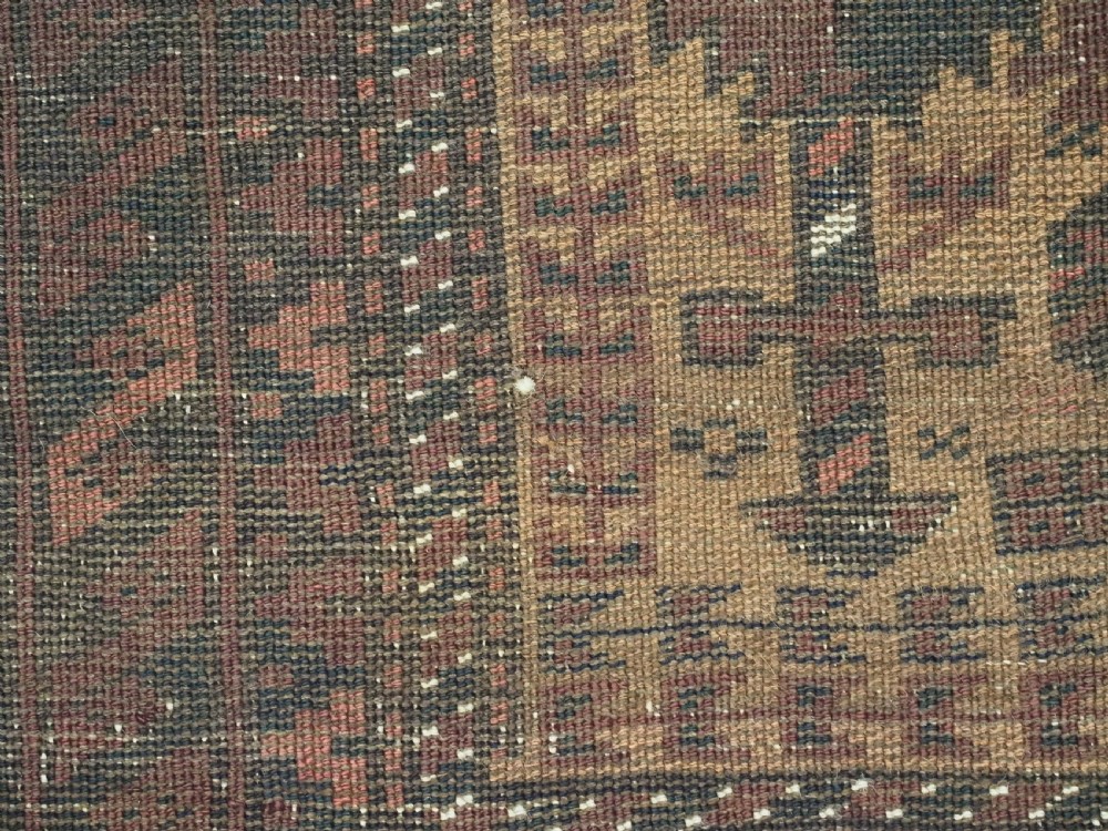 An antique woven Baluch prayer rug with a central tree of life design in camel brown and dark red tones. View XI