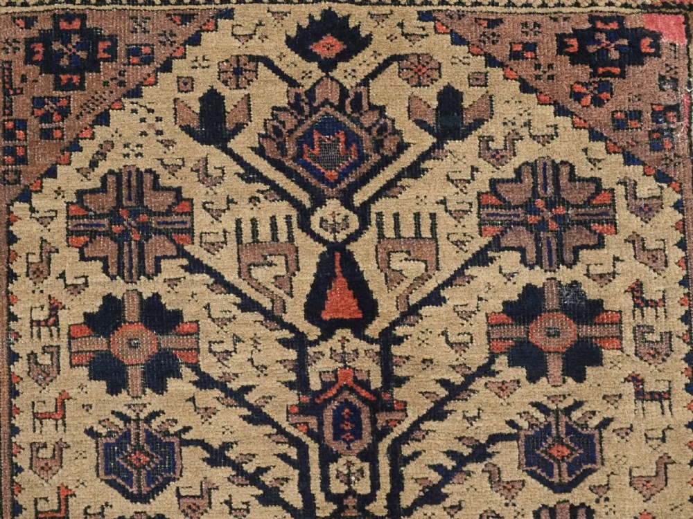 A rectangular late 19th-century Baluch tribal rug with a camel wool field, featuring a central stylised tree motif and terracotta geometric borders. View VIII