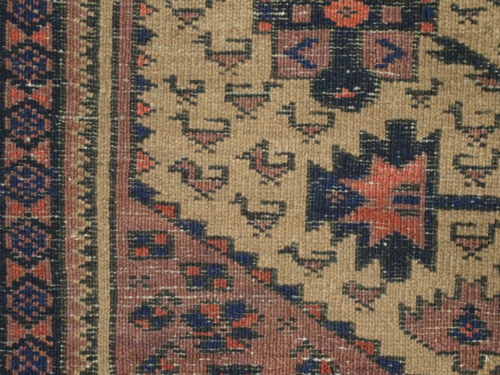 A rectangular late 19th-century Baluch tribal rug with a camel wool field, featuring a central stylised tree motif and terracotta geometric borders. View XIII