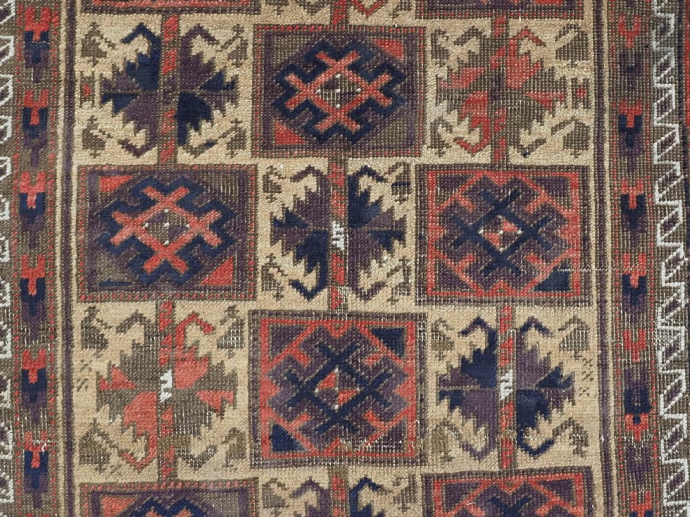 An antique hand-knotted wool prayer rug featuring a central mihrab pattern surrounded by geometric square motifs in dark brown, terracotta, and navy blue tones. View VIII