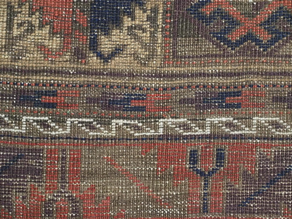 An antique hand-knotted wool prayer rug featuring a central mihrab pattern surrounded by geometric square motifs in dark brown, terracotta, and navy blue tones. View XI