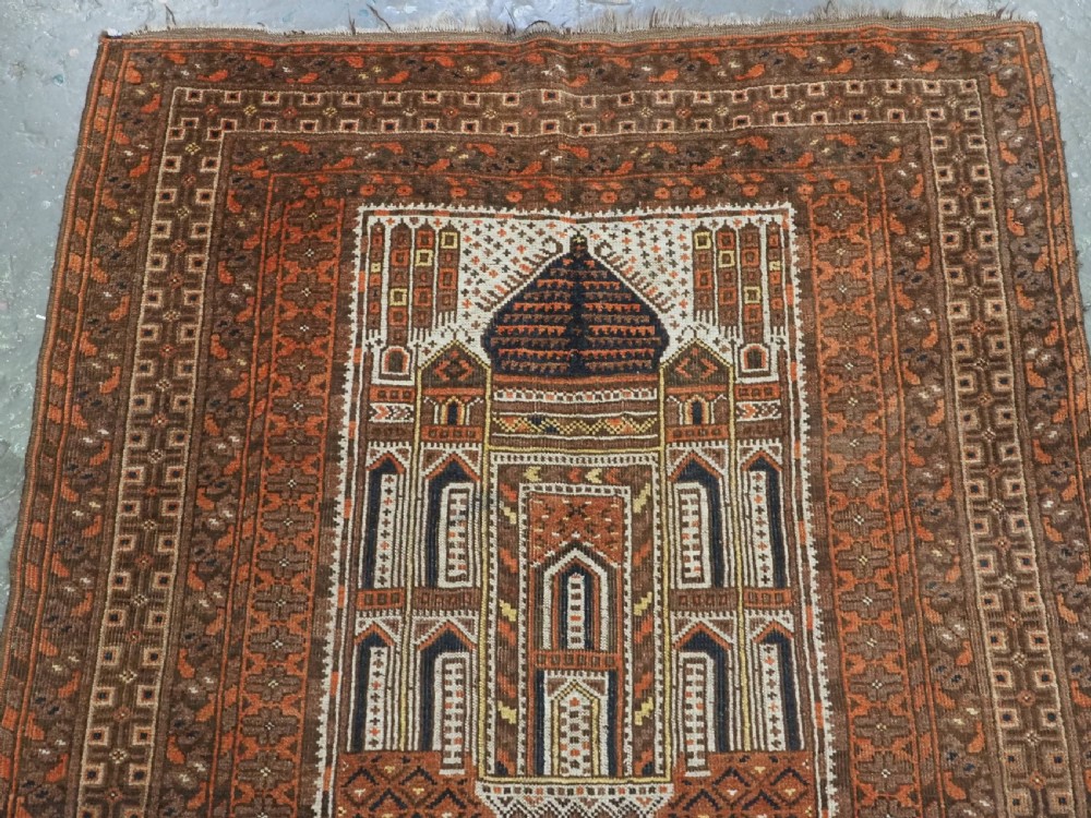 An antique Afghan Kizil Ayak hand-knotted wool rug featuring two opposing mosque niche designs in terracotta, brown, and ivory tones. View III