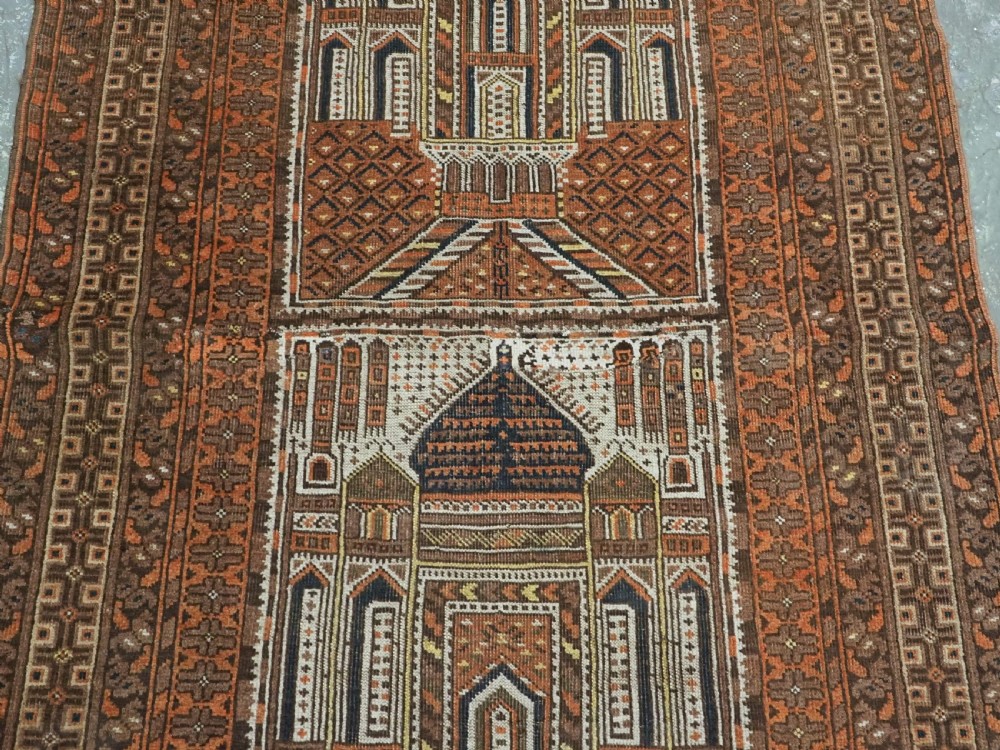 An antique Afghan Kizil Ayak hand-knotted wool rug featuring two opposing mosque niche designs in terracotta, brown, and ivory tones. View IV