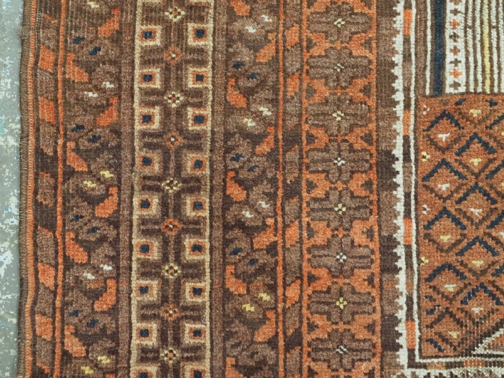 An antique Afghan Kizil Ayak hand-knotted wool rug featuring two opposing mosque niche designs in terracotta, brown, and ivory tones. View V
