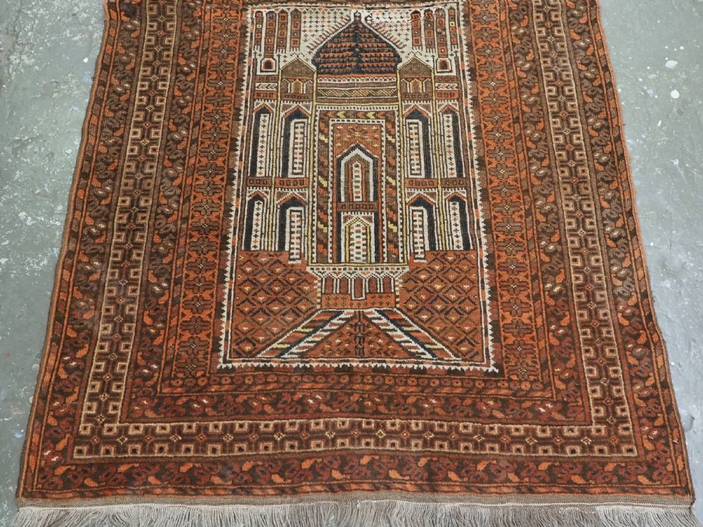 An antique Afghan Kizil Ayak hand-knotted wool rug featuring two opposing mosque niche designs in terracotta, brown, and ivory tones. View VI