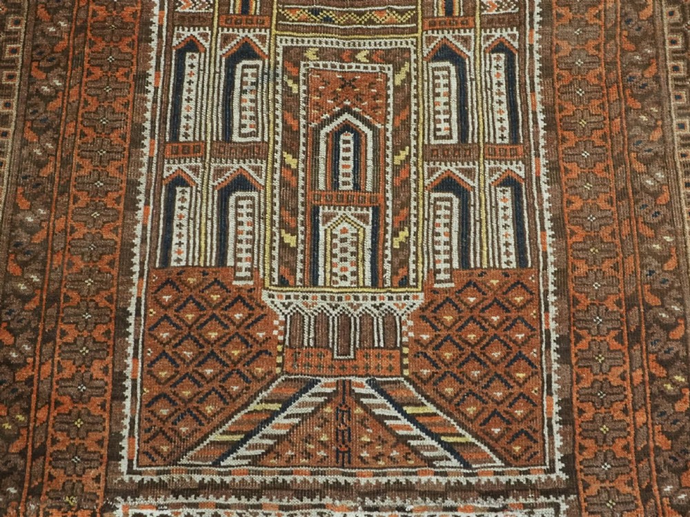 An antique Afghan Kizil Ayak hand-knotted wool rug featuring two opposing mosque niche designs in terracotta, brown, and ivory tones. View IX