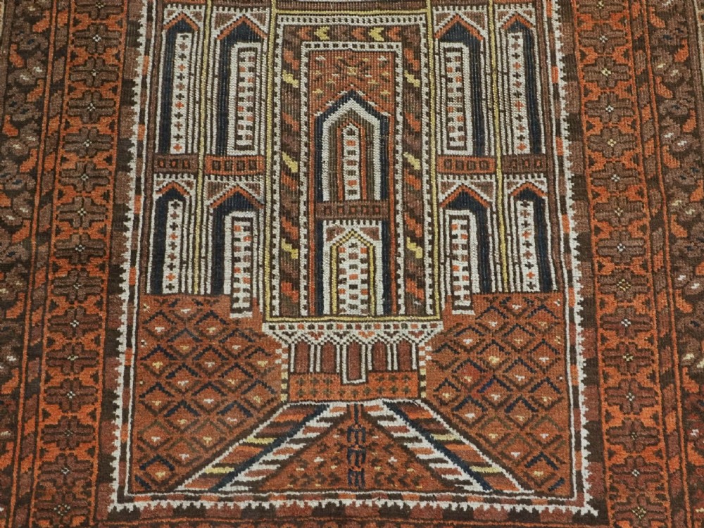 An antique Afghan Kizil Ayak hand-knotted wool rug featuring two opposing mosque niche designs in terracotta, brown, and ivory tones. View XI