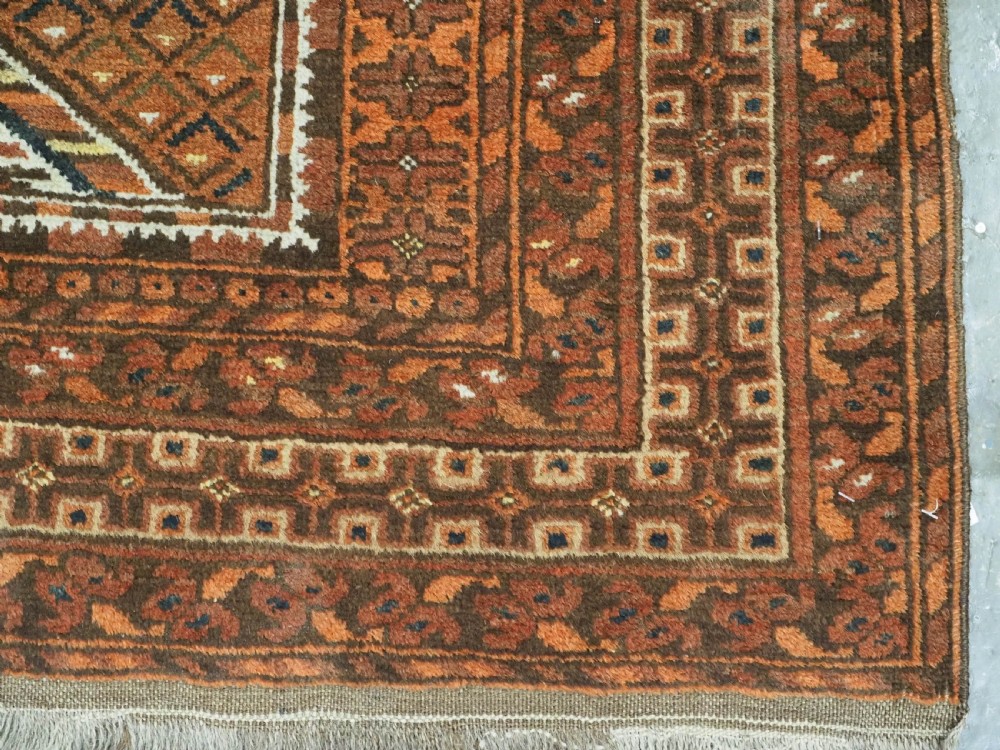 An antique Afghan Kizil Ayak hand-knotted wool rug featuring two opposing mosque niche designs in terracotta, brown, and ivory tones. View XII