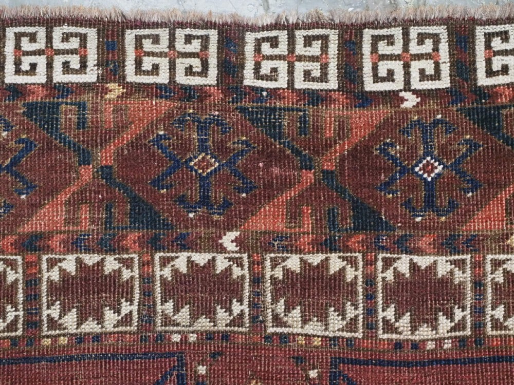 An antique Ersari Turkmen Ensi wool rug featuring a four-panel central field with tree-like motifs surrounded by geometric borders in rich shades of madder red, navy, and cream. View VIII