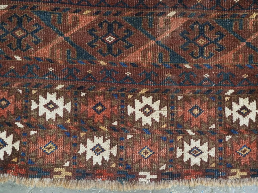 An antique Ersari Turkmen Ensi wool rug featuring a four-panel central field with tree-like motifs surrounded by geometric borders in rich shades of madder red, navy, and cream. View XIII