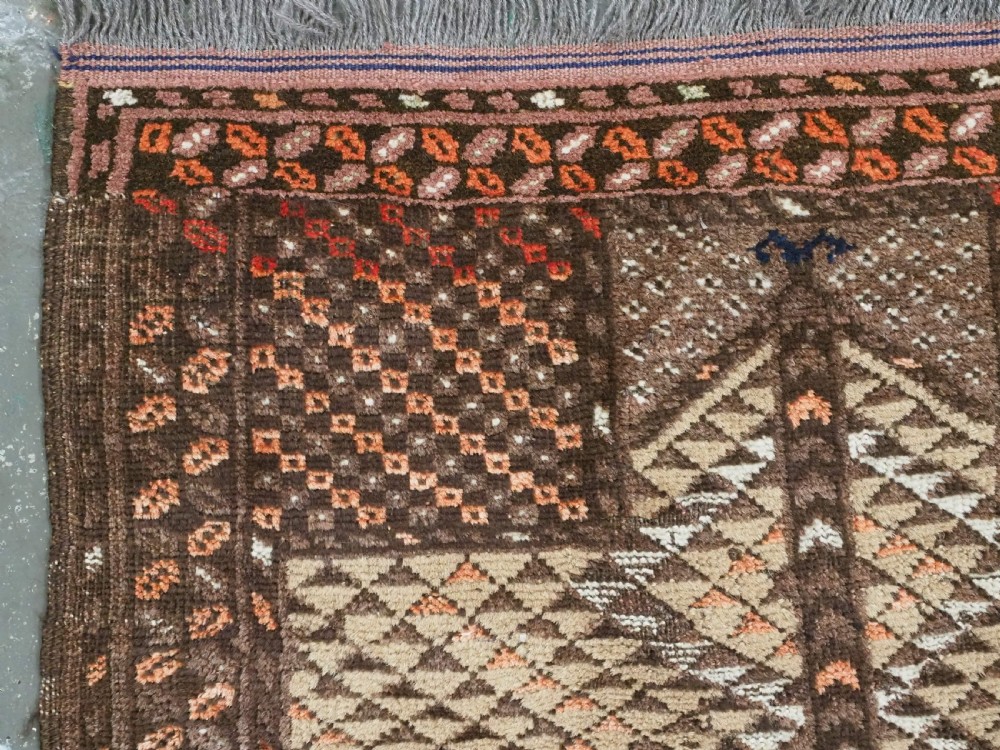 An antique hand-knotted Turkmen wool prayer rug featuring a dark brown and terracotta diamond lattice pattern with a prayer arch at the top. View VI
