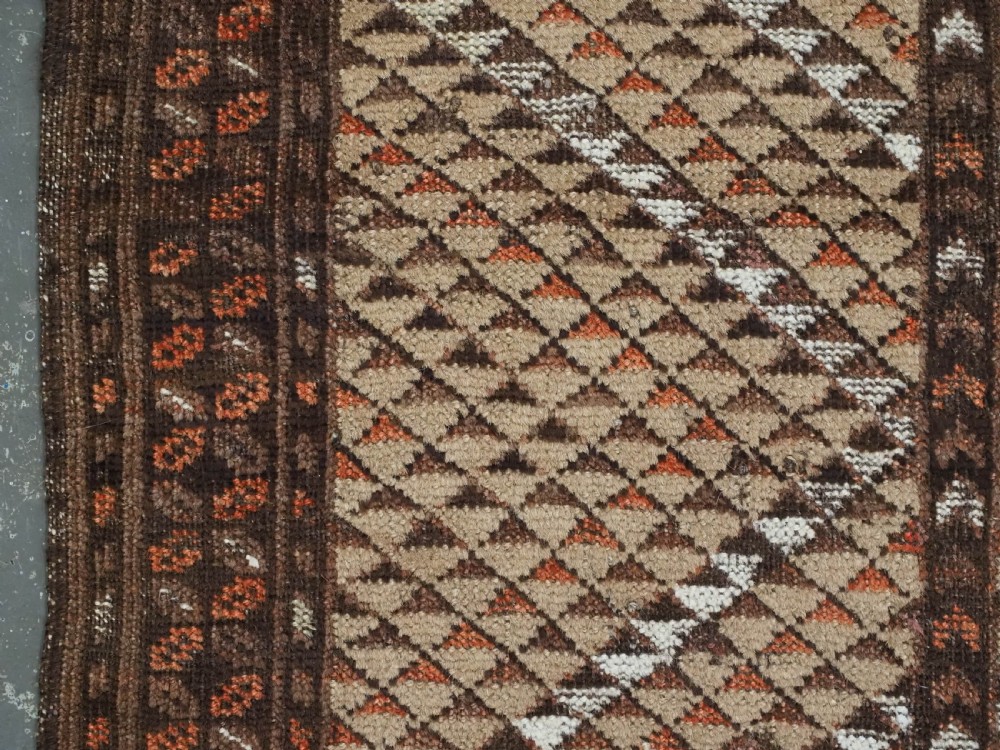 An antique hand-knotted Turkmen wool prayer rug featuring a dark brown and terracotta diamond lattice pattern with a prayer arch at the top. View VII